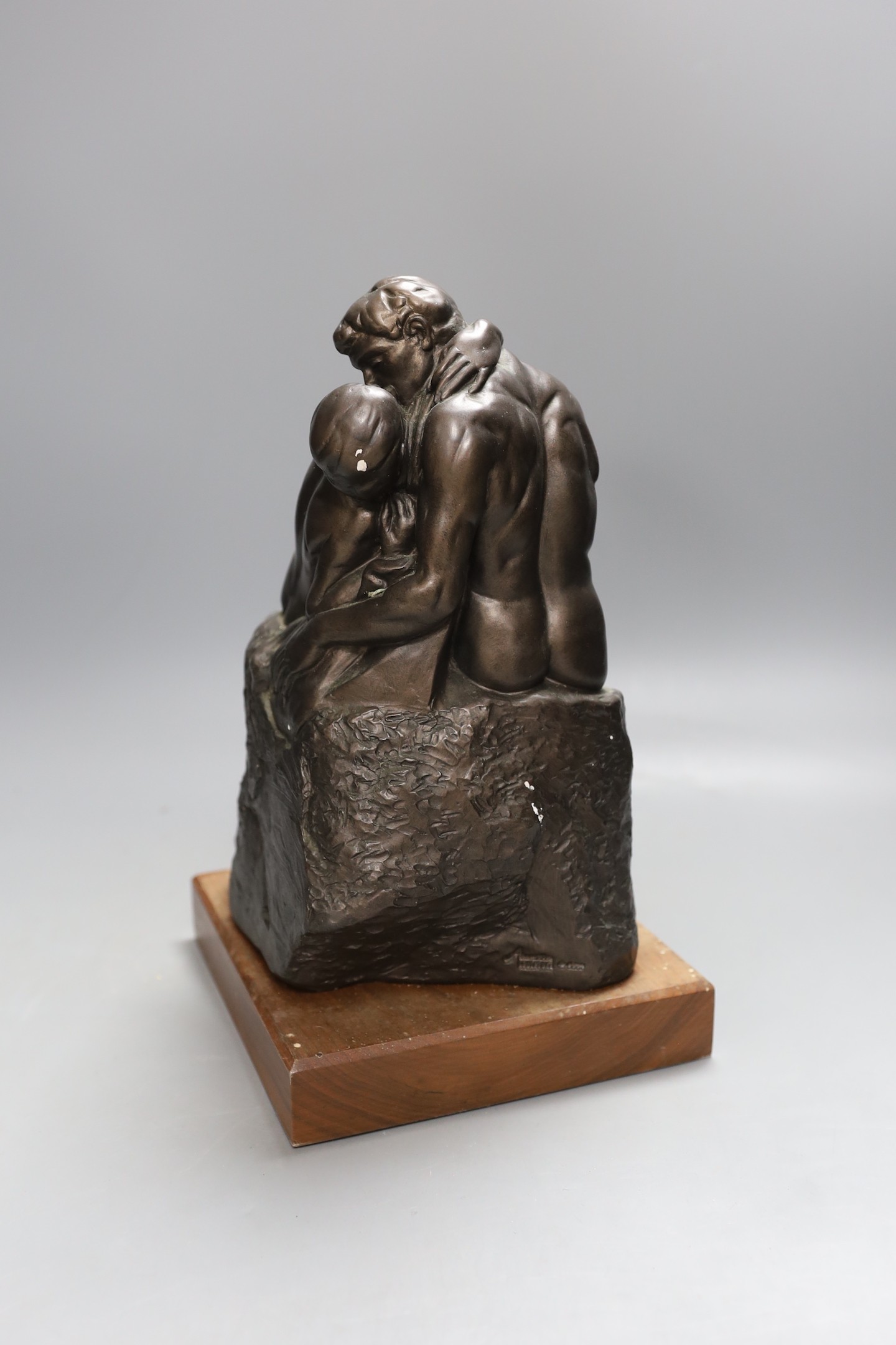 A simulated bronze figure group of seated embracing couple - 30cm tall